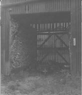 SA0512 - Exterior shot, showing wood storage and a wheelbarrow.